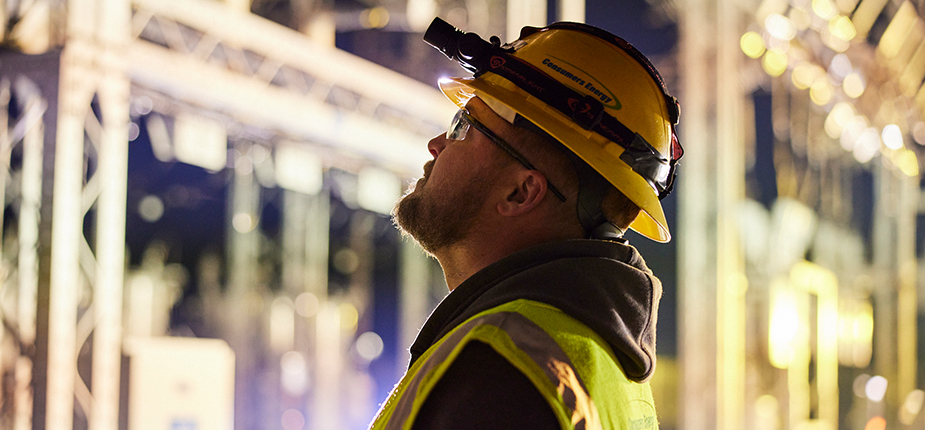 field crew worker looking at electric equipment